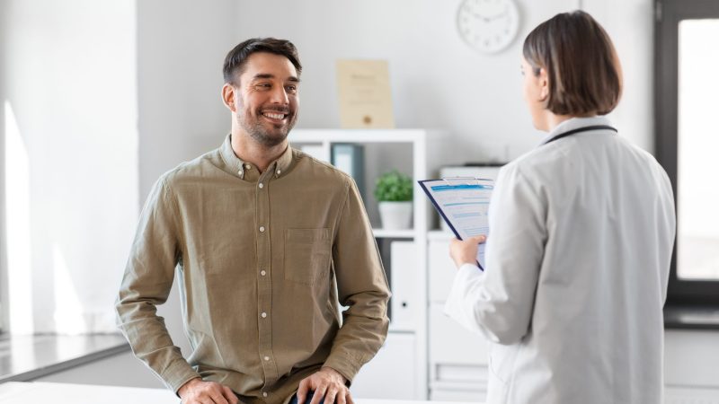 Doctor and smiling man meeting