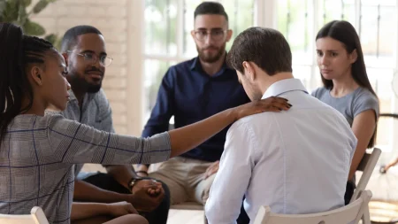A group talking about cocaine-induced psychosis and supporting a person.