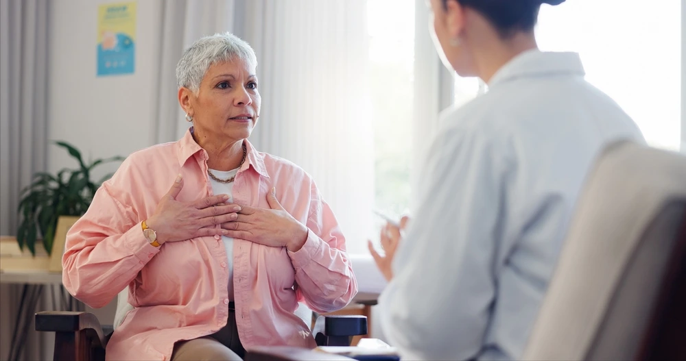 A female patient talking to a doctor about alcohol chest pains.