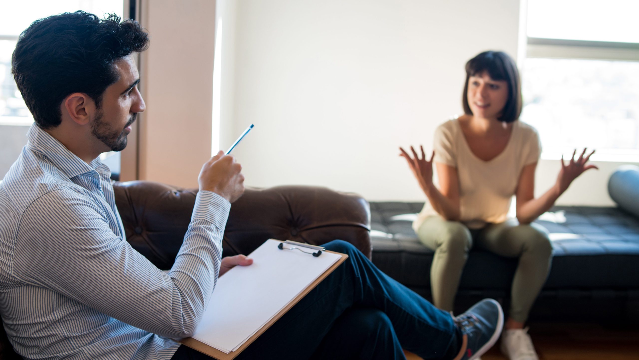 Psychologist talking with patient on therapy session