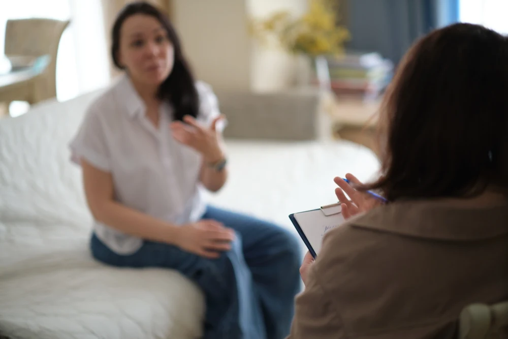 A woman discussing an alcohol hot flush with her healthcare professional.